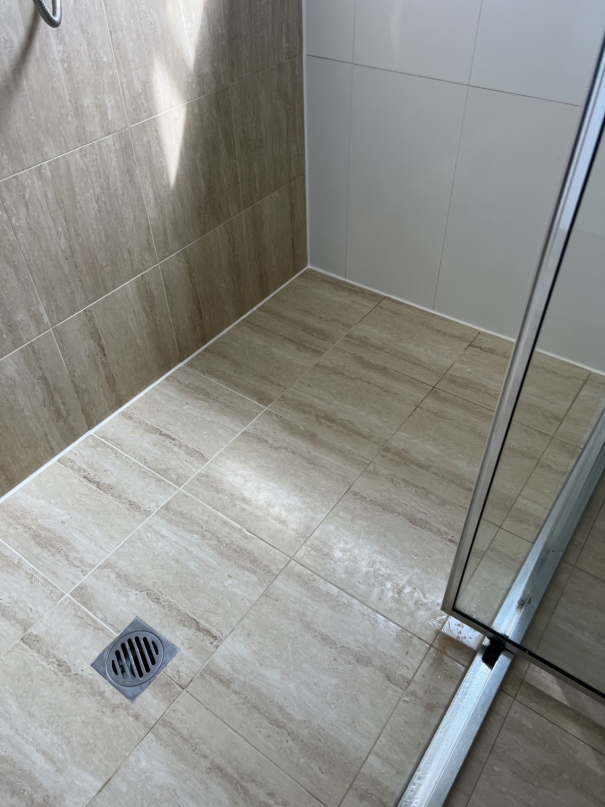 Silicone joint at shower wall/floor junction by GC Grout Masters