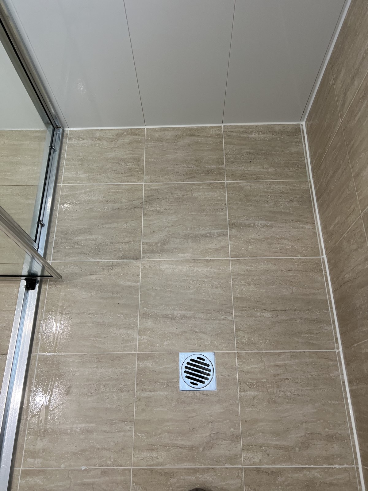 Silicone around a shower floor perimeter by GC Grout Masters